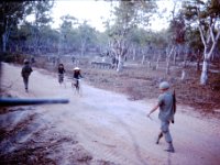 Engineers (walking) sweep the road for mines while the Cav troop secures the flanks.  One of our 113’s had been hit by a command detonated mine shortly before theses two gentlemen in black pajamas bicycled up the road. (Any connection???)
